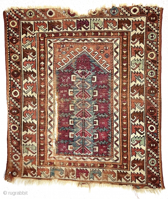 Antique little Turkish village prayer rug, possibly bergama, with some interesting design features and older colors but very rough condition. Appears both madder and cochineal reds used. Attractive ivory “leaf” border. Overall  ...