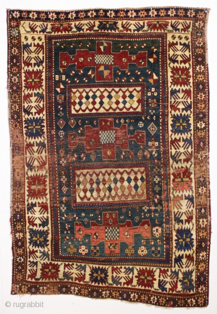 Early large kazak rug. Unusual and archaic kazak with karachopf family resemblance but on it's own branch of the family tree. I am transfixed by the mysterious ivory boxes filled with carnival  ...