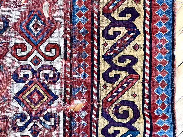 Early Kazak rug. Bold design. Top saturated natural colors. Very rough with  wear, tears, holes as shown. Reasonably clean. First half 19th c. 4’ x 5’8”      