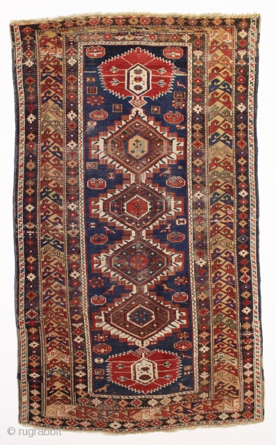 antique caucasian shirvan rug in fair condition for an older example. A karagashli variant with all natural colors featuring a pretty gold colored main border. Even low cut pile with scattered wear  ...