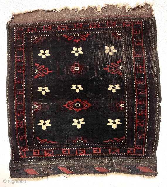 Antique Baluch weaving, either an unusually large bagface or an uncommon small mat. Spacious early drawing of classic Mina Hani design with a barely visible brown lattice on the deep blue ground.  ...