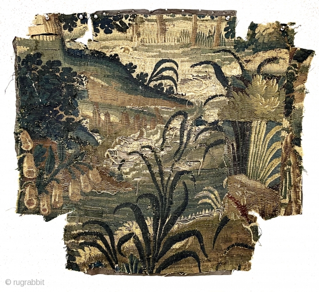 Small authentic verdure tapestry fragment, in very rough condition, likely 18th c. or earlier. As found, small holes, tears and rough edges all around. Reasonably clean. Sewn to old backing. 33” x  ...