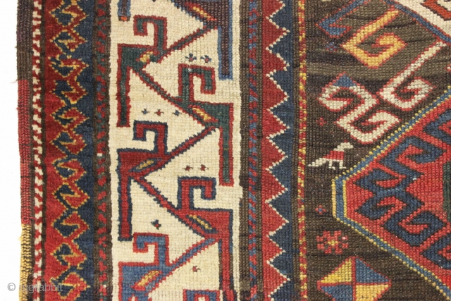 Antique caucasian rug. Unusual field and an interesting rendition of this border type. All natural colors. An unusual palette including a deep natural orange, a strong clear yellow, a dark aubergine and  ...