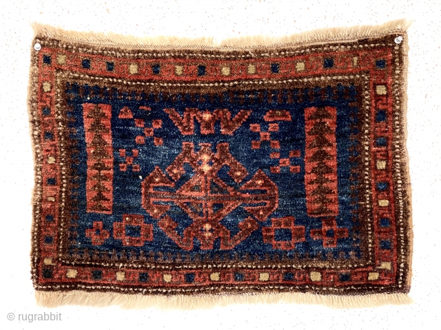 Antique unusual little blue ground Baluch bagface. A field design I have not encountered before along with an equally unusual border of hooked boxes.  Uncommon size more like a turkman mafrash.  ...