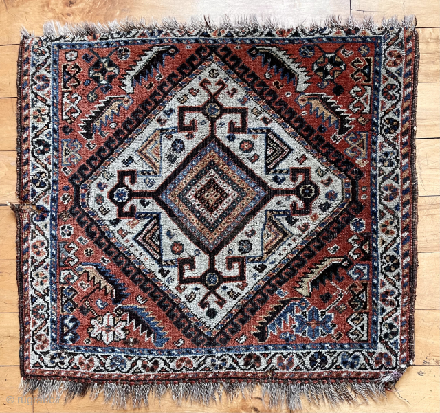 Antique little northwest Persian bagface or mat (likely). Attractive ivory medallion surrounded by scattered herati elements. Some edge unraveling and a small gouge. Good natural colors. Even low pile. Depressed weave. Could  ...