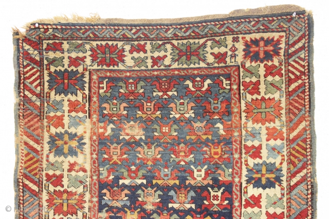 Old caucasian rug, possibly kazak, with unusually good colors but in distressed condition. The large range of natural colors contains lovely greens and blues and a very fine old apricot orange. Very  ...