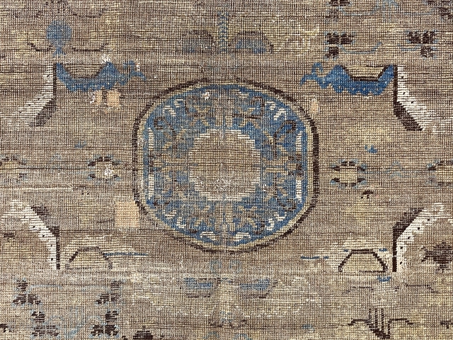 Early grand weaving, presumably Chinese, possibly kangxi, intact but thin with very low pile. Truly majestic wall piece with spacious archaic field design and beautiful eye catching borders. Small tear in upper  ...