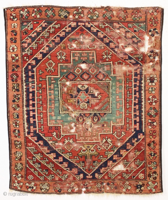 early small west anatolian rug. Old enough to have presence. All good colors. Damaged but complete. Waiting to be mounted or restored properly. Good age. First half 19th c. 4' x 4'9"  ...