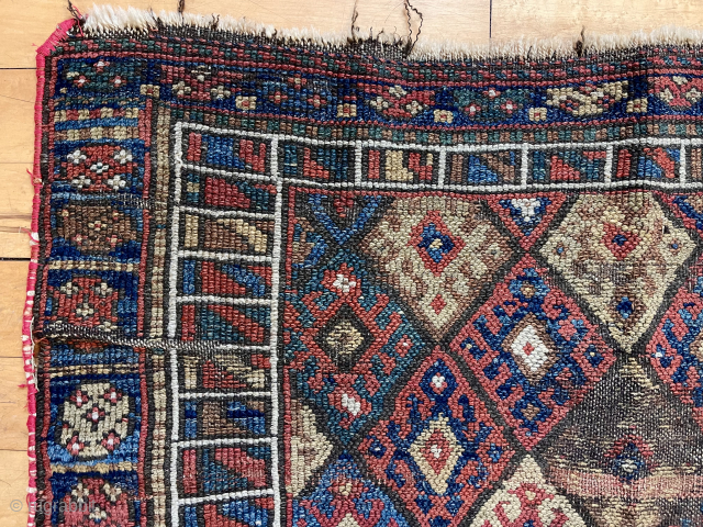 Old Kurdish diamond bagface with attractive “signal flag” border. Overall rough with heavy wear and edge unraveling. All good natural colors but very dirty. Large size. 32” x 41”. 19th c. Study  ...