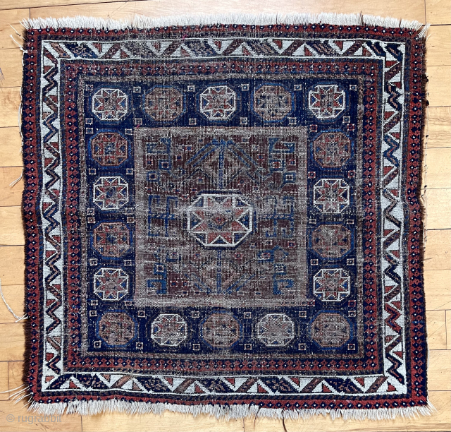 Old Baluch square middle Bagface in ghostly worn condition but with some interesting design features. Unusually large medallion and not the typical field I associate with the type. Natural colors. Rough and  ...
