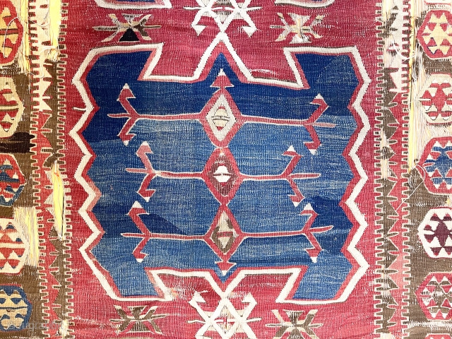Early Anatolian obruk kelim. Iconic design. Lovely early colors. Unrestored with tears, gouges and heavy brown oxidation. Fine weave and cloth like handle. One end severed right off. Technically fragmented but given  ...