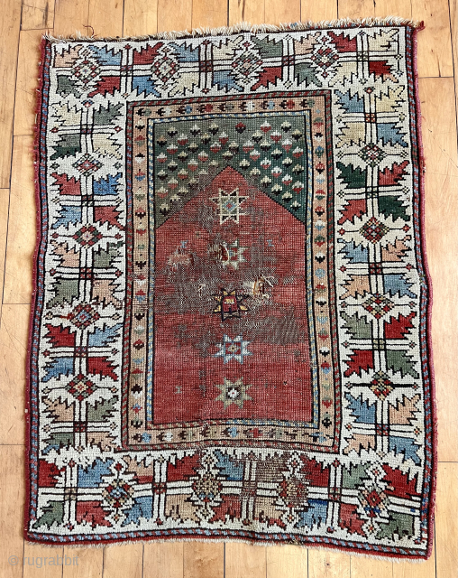 Early Anatolian village prayer rug. Eye catching border. Lovely natural colors featuring lots of soft greens. Crude repairs to very damaged center.  Needs a wash. Good age, mid 19th c or  ...