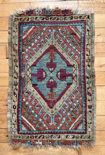Antique Anatolian yastik in good condition for the age. Mostly good pile with moderately oxidized blacks. Natural colors including multiple blues, good yellows and a rich cochineal red/purple. Original selvages. Ends unraveling  ...
