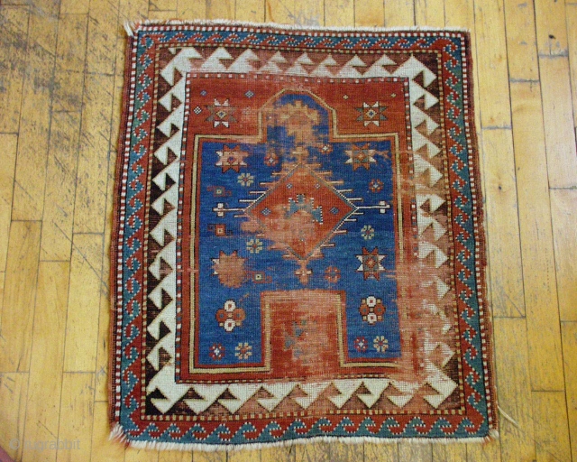 Antique very small Kazak prayer rug. Nice old piece in need of restoration. All good natural colors. Fresh and dirty. 19th c. 3' 3" x 3' 11"      