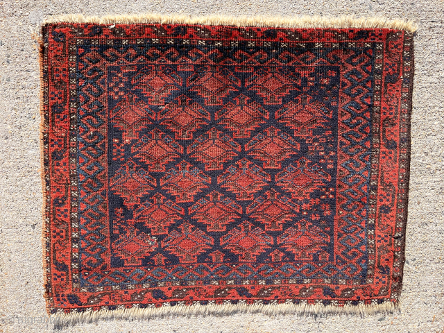 Early blue ground Baluch bagface with an overall lattice of floral pendants seen most often in so called “Dohktar i Ghazi” prayer rugs. Mostly decent pile. Few small old moth nibbles. Some  ...