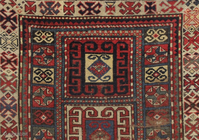 early ghost of a kazak rug. Splash of karrabaugh with a hint of karachopf. Indescribable condition. Priced accordingly. All good natural colors and reasonably clean. 3'6" x 8'3"     