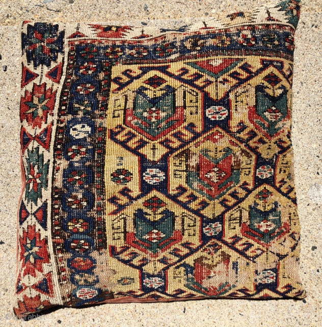 Pair of early sounak rug fragments made into pillows. Uncommon design of tulip palmettes on a soft yellow ground. Scattered wear as shown. Sewn all around and stuffed lightly. Not opened. Reasonably  ...