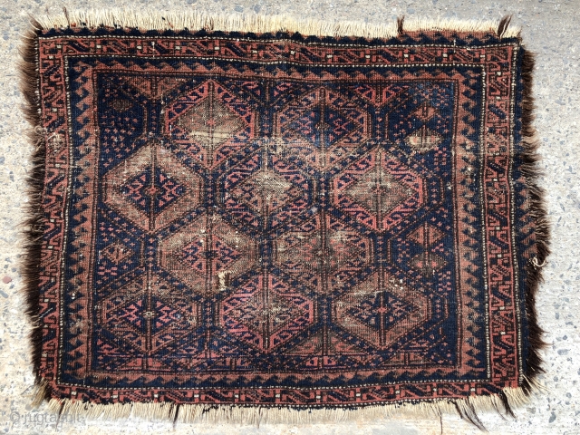 Antique Baluch bagface with classic lattice design. Older example in very worn condition and priced accordingly. Possibly of interest to someone focused on this type. All natural colors. As found in need  ...