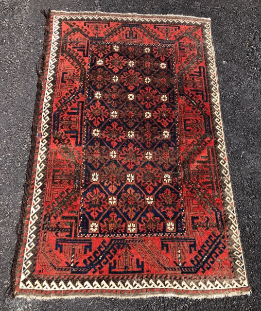 Antique Baluch rug with a delicately drawn lattice design and vine border in overall good condition. Even low pile with oxidized  browns and one penny sized crude patch. Original selvage one  ...