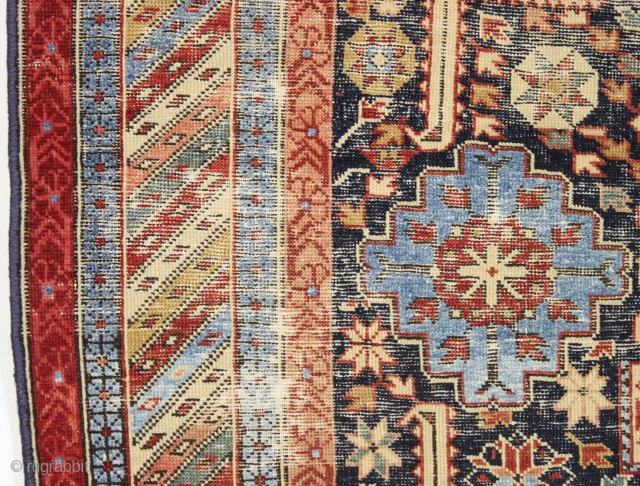 Strange remnant of an old shirvan rug with large areas of light blue cotton pile including most of the minor borders. Never seen anything quite like it before. Bad person cut rug.  ...