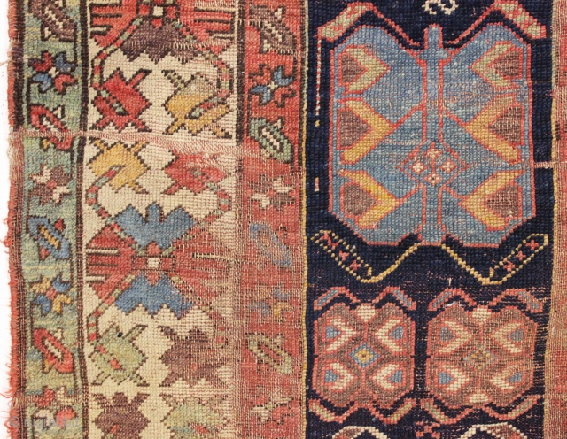 antique long rug, probably nw persian, with an interesting archaic design and older all natural colors. Note the area of white cotton pile seen clearly in back pic. In abused condition, very  ...