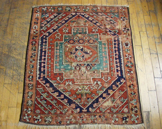 Antique west Anatolian rug.  All natural colors. Good age, certainly 1st half 19th c. Rough with low pile, wear and damage. 4' x 4' 9"
       