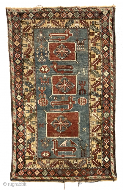 Antique small Caucasian rug in good condition with a dramatic design and attractive colors featuring a lovely yellow main border. The easily recognized karagashli type motifs and numerous animals float on a  ...