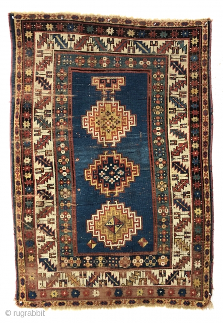 Early small Kazak. Spacious and fluid drawing. An older example of a well known design group. All natural colors. Overall even low pile with scattered wear, heavy brown oxidation and creases as  ...