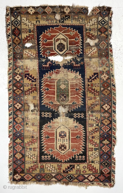 Early east Caucasian rug. Interesting karagashli variant. In rough condition with wear, oxidized browns, holes and edge loss. All natural colors featuring a strong yellow/gold and a fine old green. Good weave.  ...