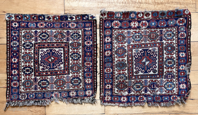 Original pair of soumak bagfaces. Ivory ground. Interesting design. Good natural colors with yellow highlights. Rough edges and some torn wefting on one. Reasonably clean. 19th c. Each app 21” sq.  