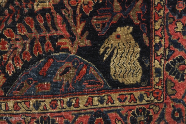 four bunnies of the apocalypse. Antique sarouk rug with four rabbits and six great birds. As found, very dirty with wear and end unraveling as shown. Old residual glue or rug pad  ...