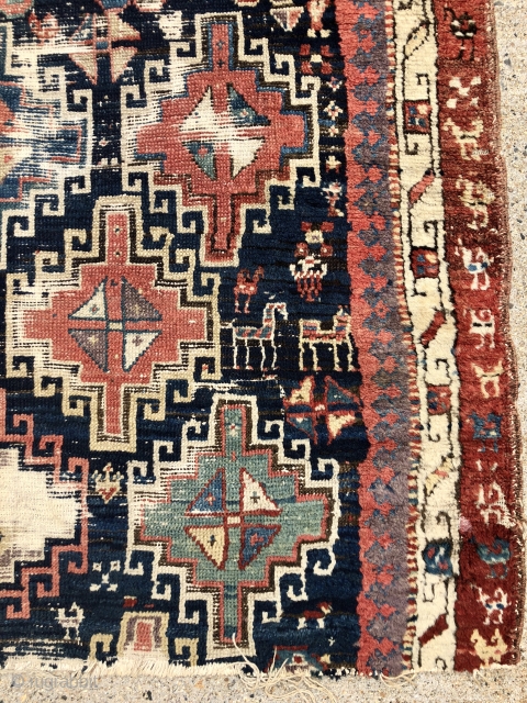 Early tribal rug fragment, probably northwest Persian with an interesting design featuring large memling guls and colorful endless knots. Add in many little animals and you have quite a charming weaving. All  ...