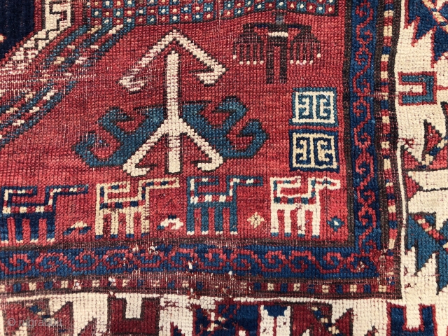 Antique Kazak rug fragment with a charming row of animals. Some decent pile. Some wear and brown oxidation. Edges all tattered. Reasonably clean. Offered for project or pillow? 19th c. 3’3” x  ...