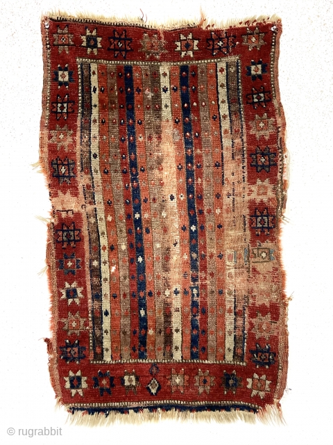 Early Anatolian yastik. Unusual palette for a stripe or cane design field. All natural colors including a lovely soft purple. Remnant original selvages. Substantial wear, small hole, edge unraveling and end loss.  ...