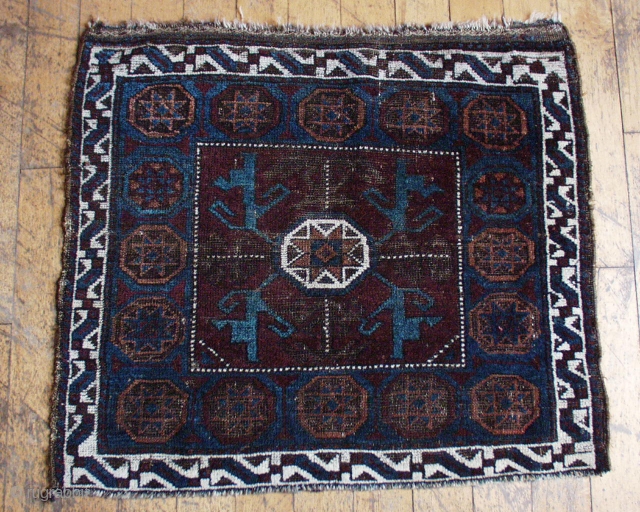 Antique Baluch octagon bagface. Unusual coloring. Nice blues. Very low pile with wear and oxidized browns. All good colors. 19th c. 27" x 29"         