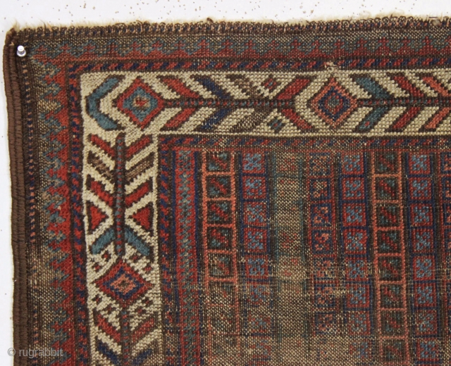 early little baluch rug with an unusual field design and colorful "fish bone" border generally found on older bagfaces. Turkish knotted. Abused and damaged but perhaps of interest to the baluch collector.  ...