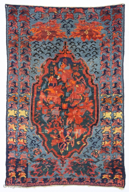 antique seichour rug. Wild and wonderful, a Rorschach test of design. Typical mix of brilliant natural and likely synthetic colors. Overall good condition with good pile. A few tiny spots of black  ...