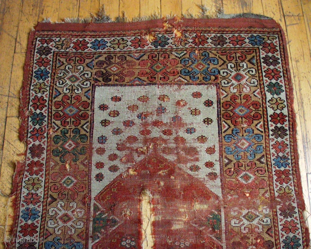 Antique Turkish Melas prayer rug. Early example in rough condition. Spacious drawing and beautiful old colors. Thin and low and damaged. Transcendental. Not for the condition minded.  3' 5"  x  ...