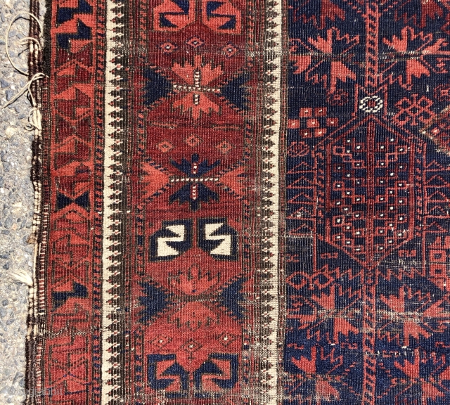 Early blue ground Baluch rug. A small timuri main carpet? Good variety of archaic field motifs and an elegant border. All natural colors. Overall thin with very low pile with areas of  ...