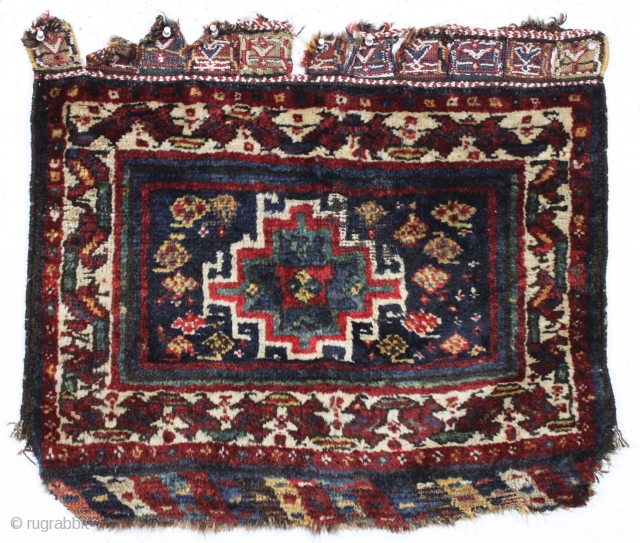 antique persian bagface. "as found", mostly good thick pile, some wear and edge damage as shown. Fancy closure tabs with cotton highlights. Dark and mysterious. Maybe Luri or Baktiari? 19th c. 26"  ...