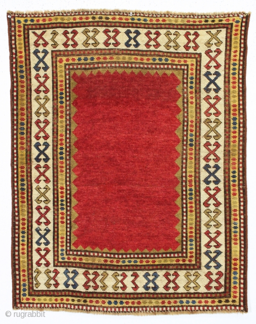 antique very small kazak rug with a mystifying empty field. Good even low pile. All lovely natural colors. Clean. A little jewel. ca. 1875 2'10" x 3'7"      