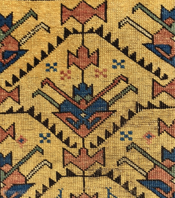 Antique yellow ground Caucasian rug, probably Avar, with a spacious lattice of large tulip palmettes. Overall even very low pile with scattered wear as shown. Small edge tear and a spot or  ...