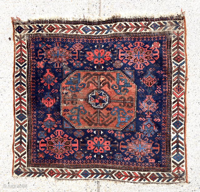 Early Baluch “octagon” bagface with first rate colors featuring as saturated a red and light blue as you can find. Eye catching field and attractive “fish bone” border. Fair condition for the  ...