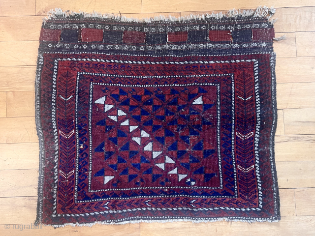 Antique Baluch bagface. Yes it has wear, low pile and scattered little moth nibbles. It has an unusual field design and two distinct reds I don’t recall seeing before. Needs a wash. ...