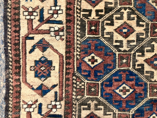 Antique Baluch rug with large scale Memling guls on a soft honey colored ground. Spaciously drawn older type border. Overall fair condition for an older piece with mostly good even pile. Moderately  ...