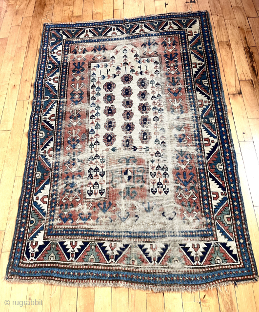 Old Kazak prayer rug. Quite worn but some interesting design features. Natural wool wefting. Could use a good wash. Study piece, priced accordingly. Dated 1291 = 1874
51” x 76”    