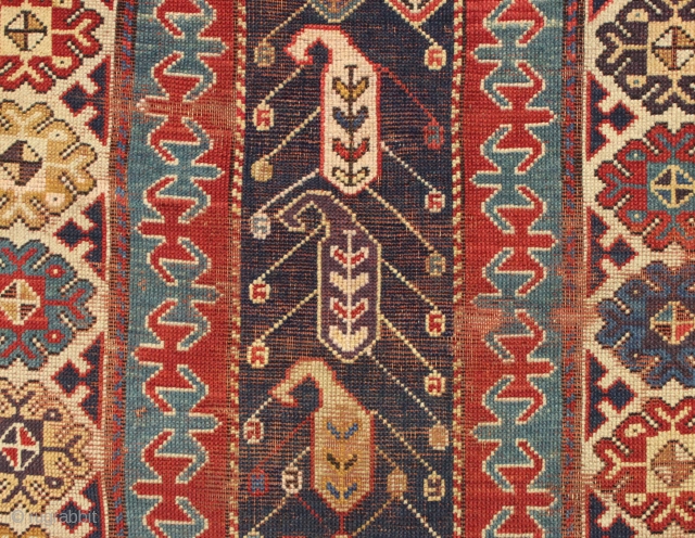 Early caucasian rug. Boteh or boats with oars? Unusually dynamic drawing both in field and borders. I have never seen a field drawn like this. All natural colors including a splendid old  ...
