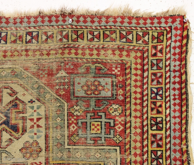 Ghostly antique caucasian rug with an interesting design featuring an unusual border. "As found", thin with allover wear. Appears to have all good original colors. Archaic drawing and not restorable. An interesting  ...