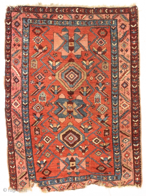 antique little northwest Persian rug with an eye catching design. Beautiful colors. Unfortunately another rug ravaged by wolves. Great repair project. ca. 1900-1920.
4'2" x 5'6"        
