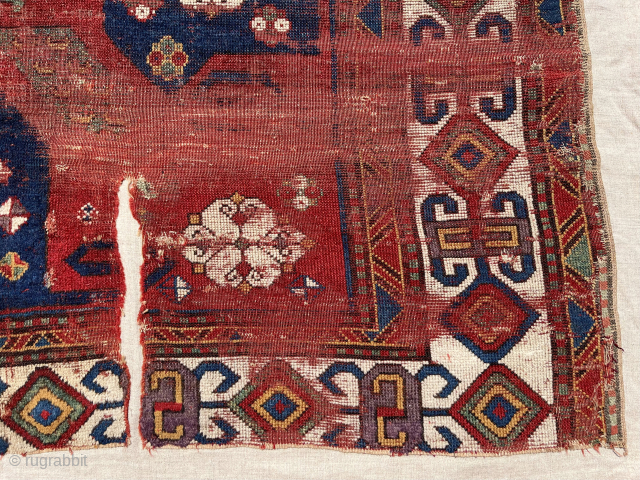 Early pin wheel Kazak fragment. Lovely old colors including eye catching purples. 
Mounted on fabric. Ca. 1800 - 1825. Fragment 3’3” x 5’10”          